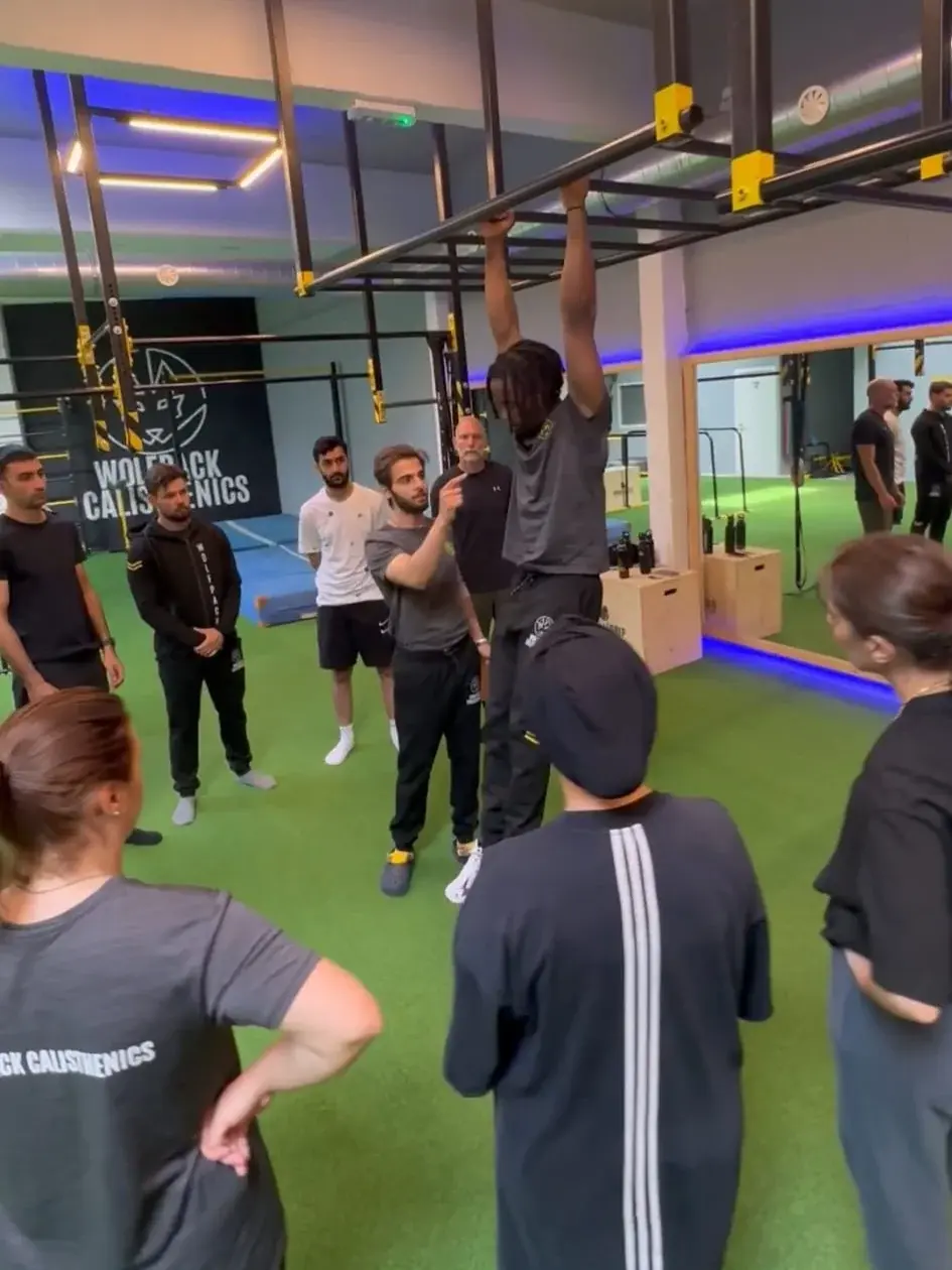 Een coach geeft uitleg over een bovenhoofdse beweging
